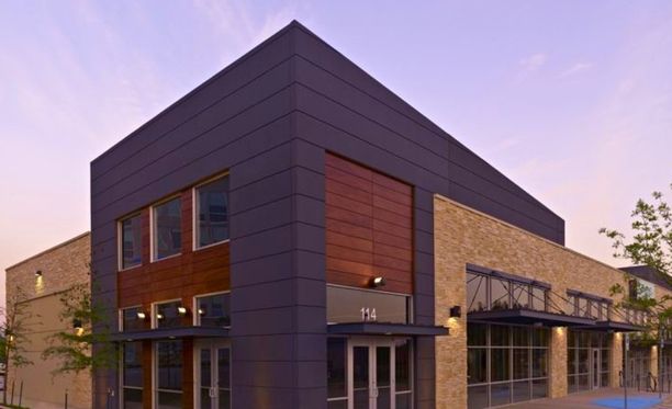 Visually striking modern commercial property exterior highlighting professional color balance on panels, brick, and trim finishes.