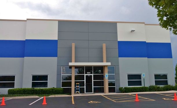Clean and durable blue and grey commercial exterior paint finishes on a local business facility facade.